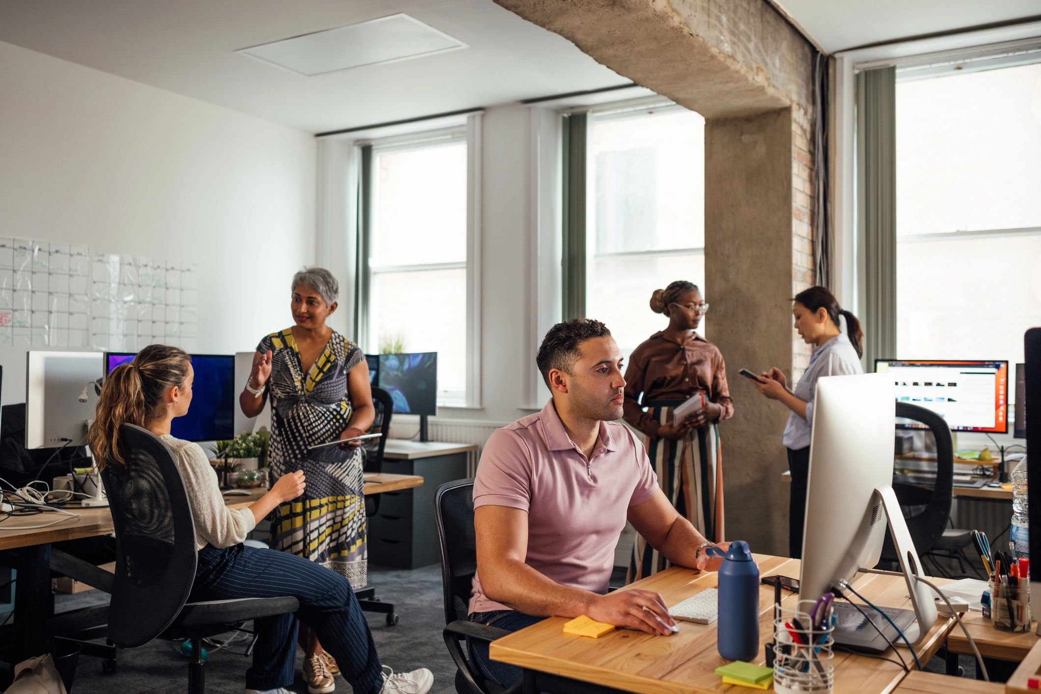 SaaS leadership team working together in an office